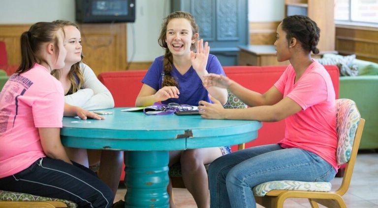 Female HSU students conversing in a residential hall.